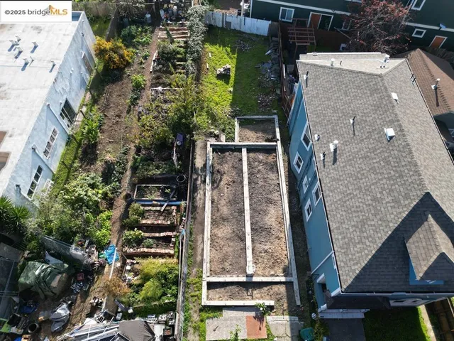 an aerial view of a residential apartment building with a yard
