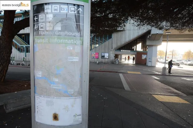 a view of a house with brick walls and plants next to a road