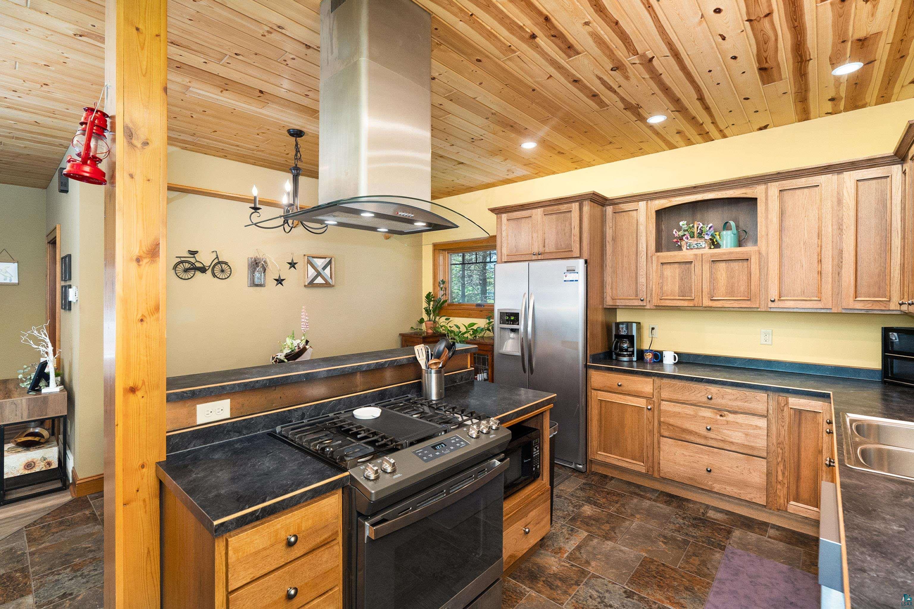75 East Stark Road Esko, MN 55733 - Photo 21 of 87 Kitchen featuring wood-finish cabinetry, stainless steel appliances, and dark stone-look countertops