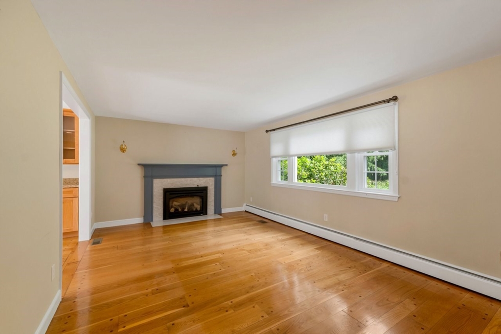 252 Littlefield Road Boxborough, MA 01719 - Photo 11 of 40 a view of an empty room with a window and fireplace