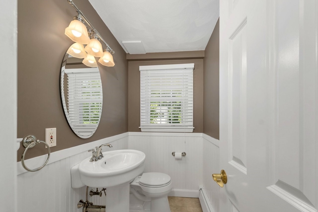 252 Littlefield Road Boxborough, MA 01719 - Photo 13 of 40 a bathroom with a toilet sink and mirror