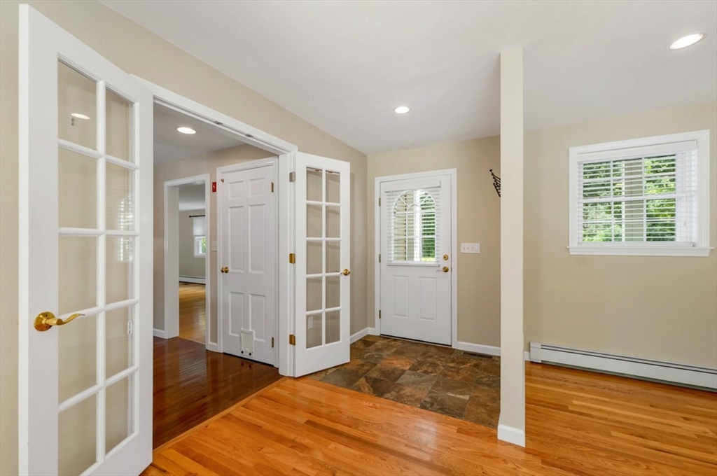 252 Littlefield Road Boxborough, MA 01719 - Photo 14 of 40 a view of a hallway with wooden floor and closet area