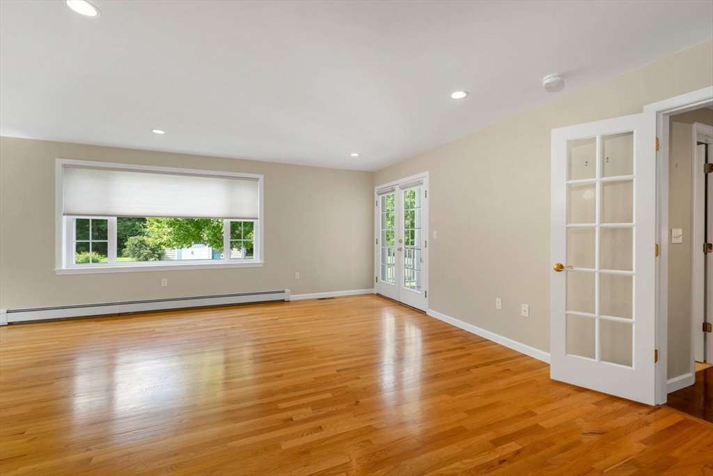 252 Littlefield Road Boxborough, MA 01719 - Photo 15 of 40 an empty room with wooden floor and windows