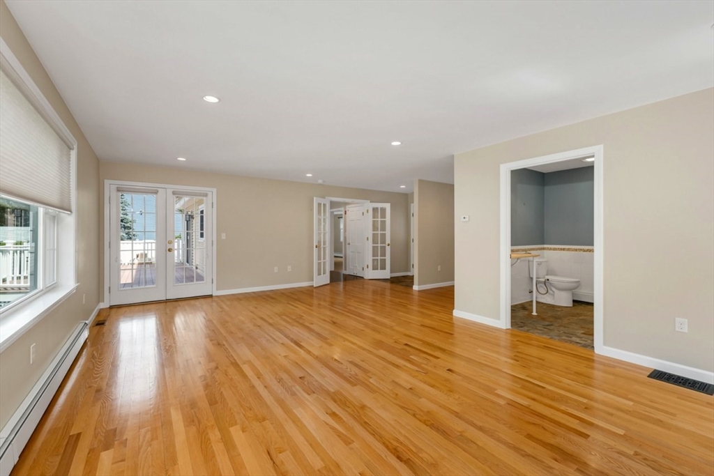 252 Littlefield Road Boxborough, MA 01719 - Photo 16 of 40 a view of an empty room with wooden floor and a window
