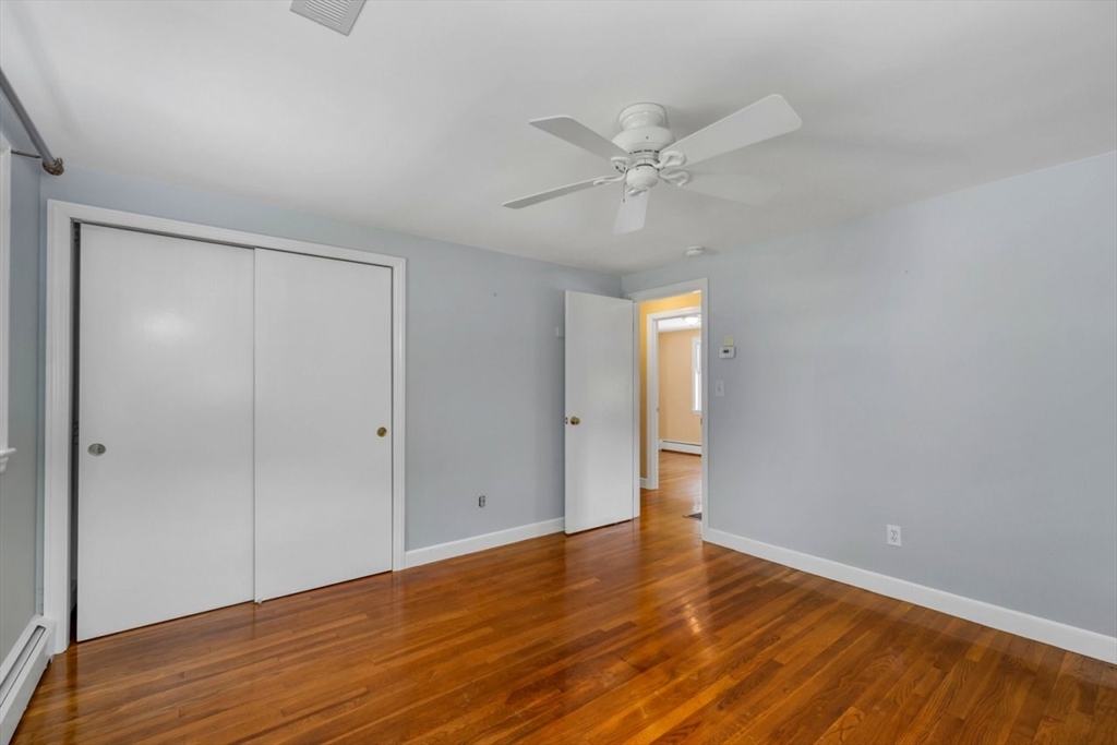 252 Littlefield Road Boxborough, MA 01719 - Photo 23 of 40 a view of an empty room with wooden floor