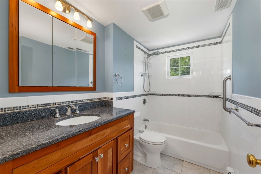 252 Littlefield Road Boxborough, MA 01719 - Photo 34 of 40 a bathroom with a granite countertop sink toilet and shower