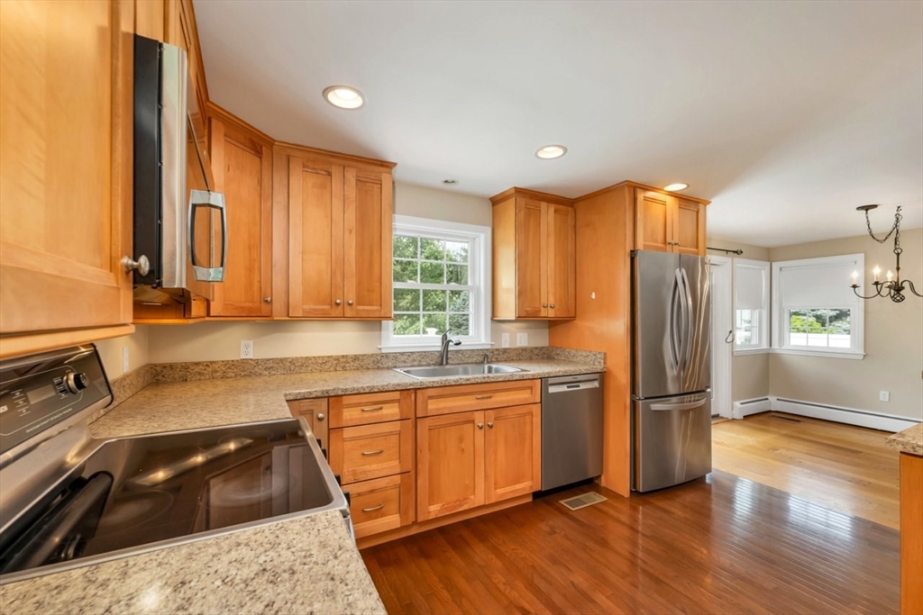 252 Littlefield Road Boxborough, MA 01719 - Photo 5 of 40 a kitchen with a refrigerator a sink and a stove top oven
