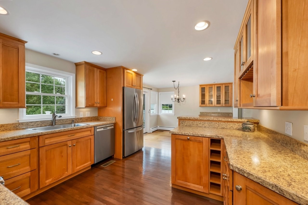 252 Littlefield Road Boxborough, MA 01719 - Photo 6 of 40 a kitchen with stainless steel appliances granite countertop a sink a stove and refrigerator