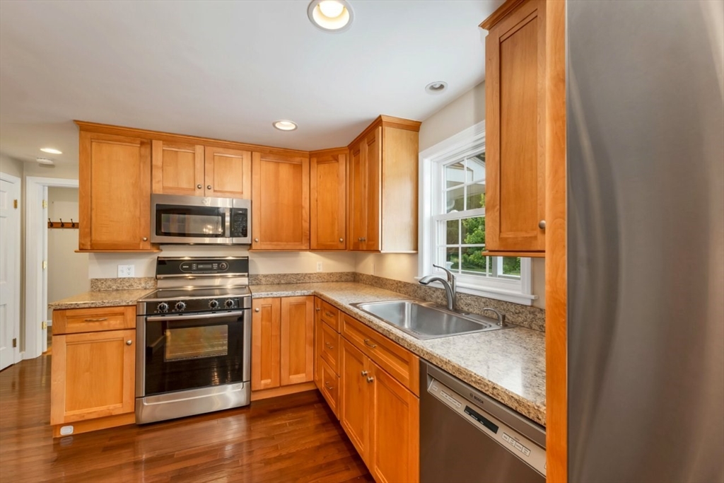 252 Littlefield Road Boxborough, MA 01719 - Photo 7 of 40 a kitchen with stainless steel appliances granite countertop a stove a sink and a microwave