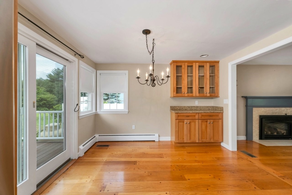 252 Littlefield Road Boxborough, MA 01719 - Photo 8 of 40 a view of an empty room with a window and fireplace