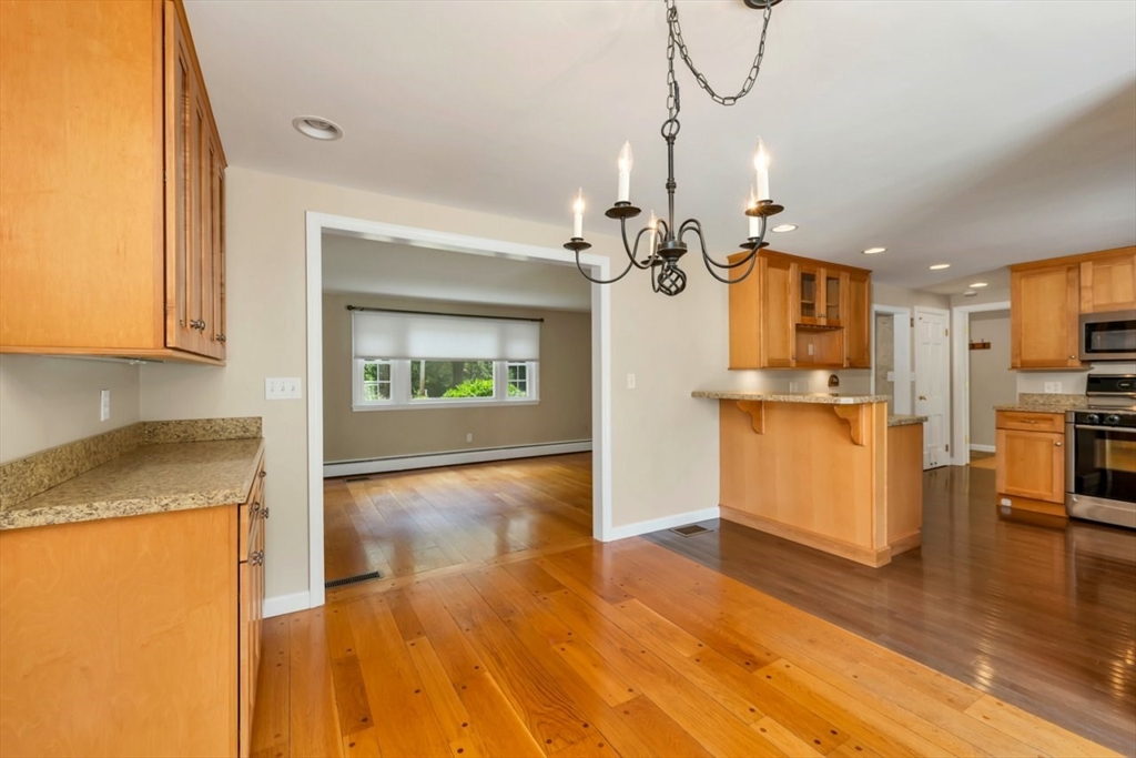252 Littlefield Road Boxborough, MA 01719 - Photo 9 of 40 a view of a kitchen with wooden floor and a kitchen
