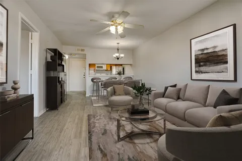 a living room with furniture and a chandelier