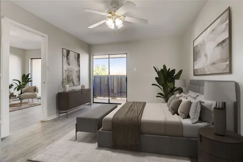 a bedroom with a large bed and a chandelier