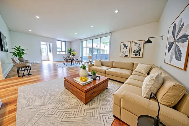 a living room with furniture a rug and a table