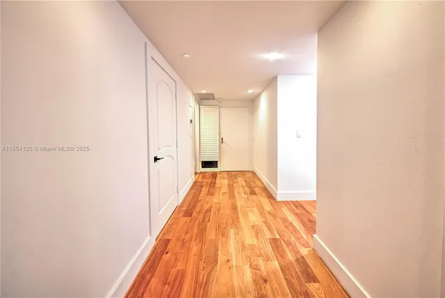 a view of hallway with wooden floor