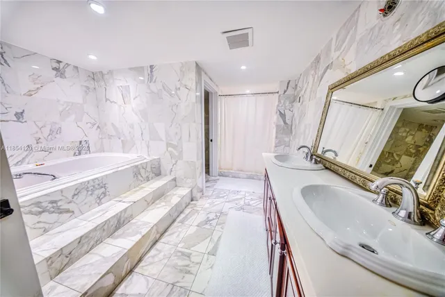 a bathroom with a tub sink and mirror