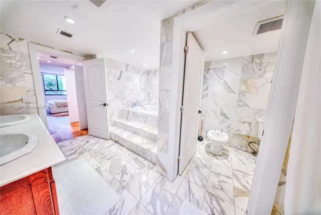 a spacious bedroom with a large bed and a shower