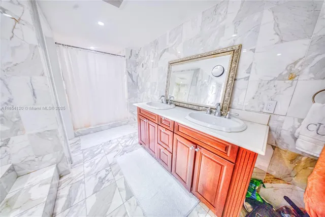 a bathroom with a sink a mirror and a bathtub