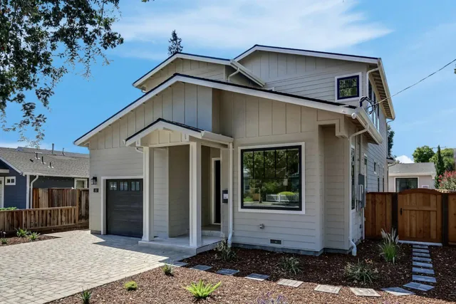 a view of a house with wooden fence