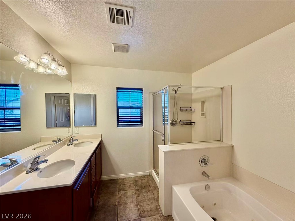 11183 Ranch Valley Street Las Vegas, NV 89179 - Photo 11 of 19 Double vanity and a deep soaking tub await in this well-appointed bath.