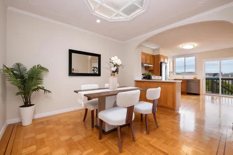a dining room with furniture and window