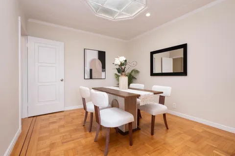 a view of a dining room with furniture and wooden floor