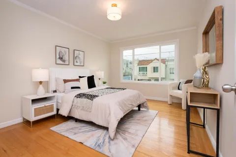 a spacious bedroom with a bed and a large window