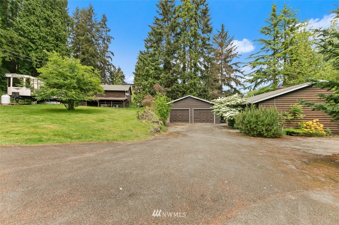 23525 27th Avenue Southeast Bothell, WA 98021 - Photo 1 of 40 a front view of a house with a yard and garage