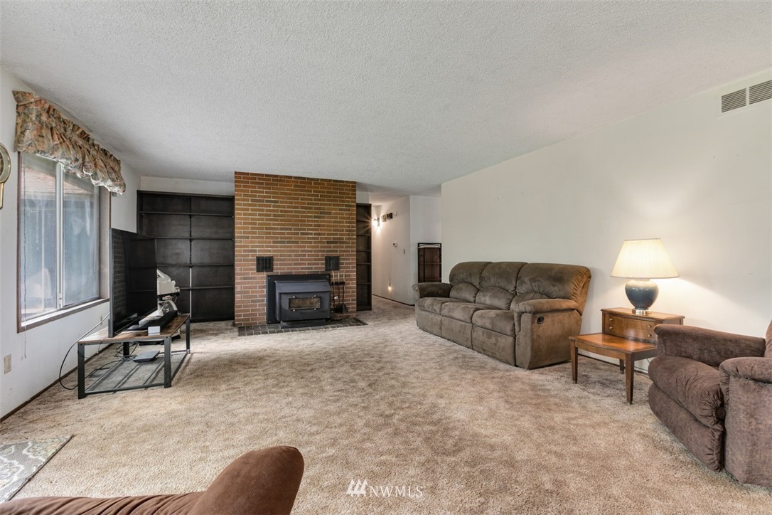 23525 27th Avenue Southeast Bothell, WA 98021 - Photo 11 of 40 a living room with furniture and a fireplace