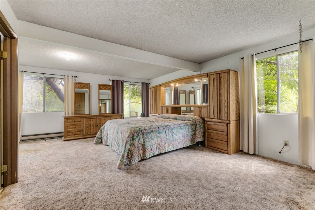23525 27th Avenue Southeast Bothell, WA 98021 - Photo 15 of 40 a spacious bedroom with a bed and large windows