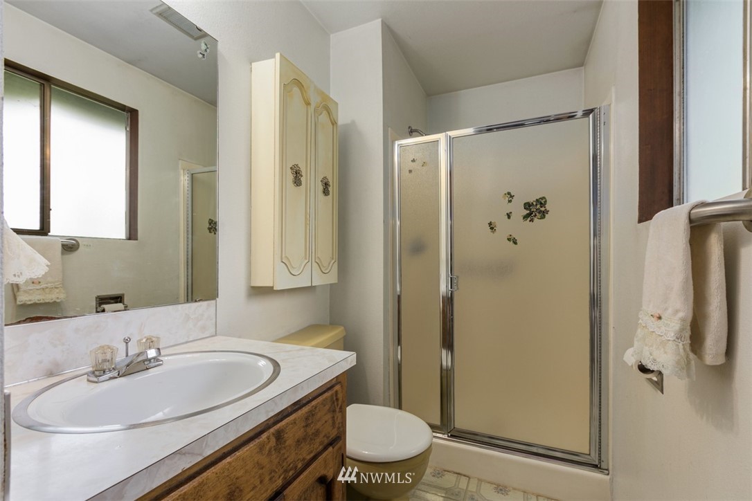 23525 27th Avenue Southeast Bothell, WA 98021 - Photo 16 of 40 a bathroom with a granite countertop sink toilet and shower