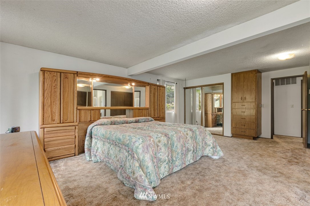 23525 27th Avenue Southeast Bothell, WA 98021 - Photo 17 of 40 a bedroom with a bed and large windows