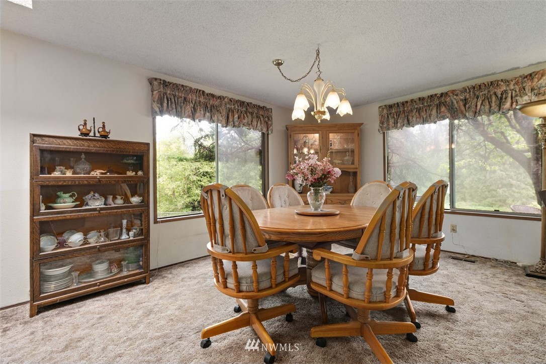 23525 27th Avenue Southeast Bothell, WA 98021 - Photo 5 of 40 a view of a dining room with furniture wooden floor and chandelier