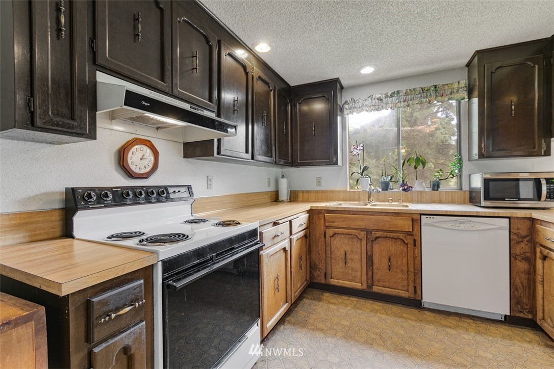 23525 27th Avenue Southeast Bothell, WA 98021 - Photo 8 of 40 a kitchen with stainless steel appliances granite countertop a stove and a sink