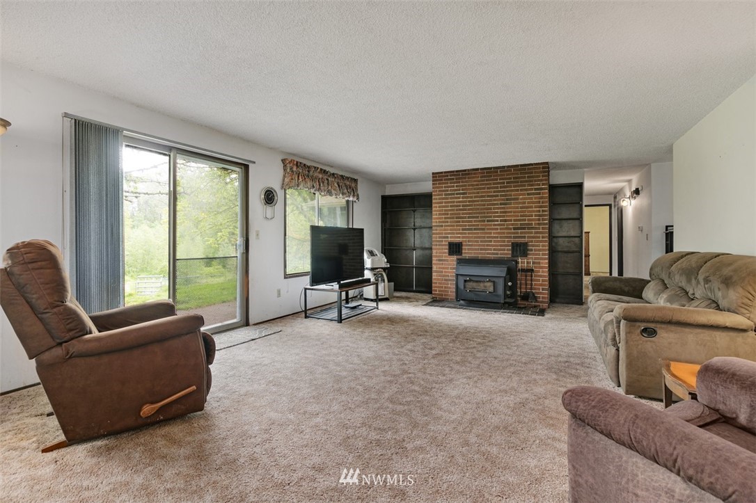 23525 27th Avenue Southeast Bothell, WA 98021 - Photo 10 of 40 a living room with furniture and a flat screen tv