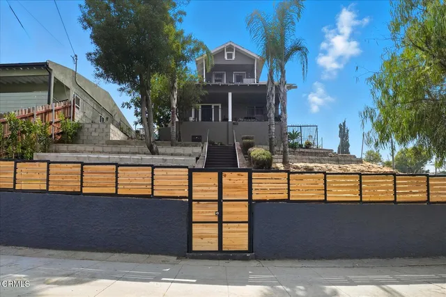 a view of a brick house with large windows