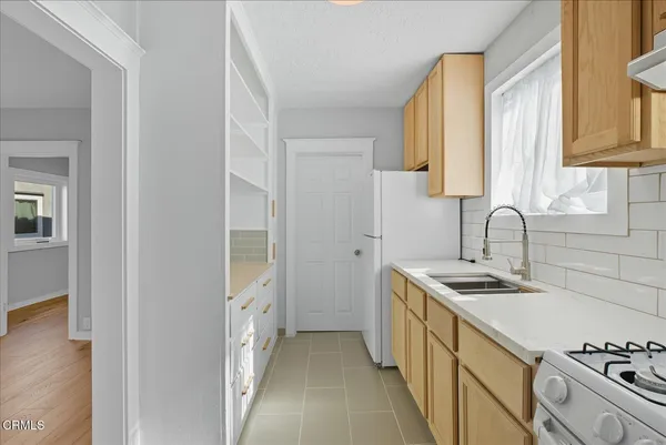a kitchen with stainless steel appliances granite countertop a sink and a stove