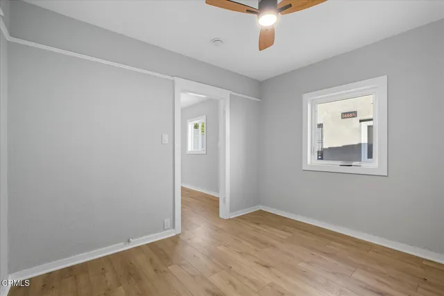 wooden floor in an empty room with a window