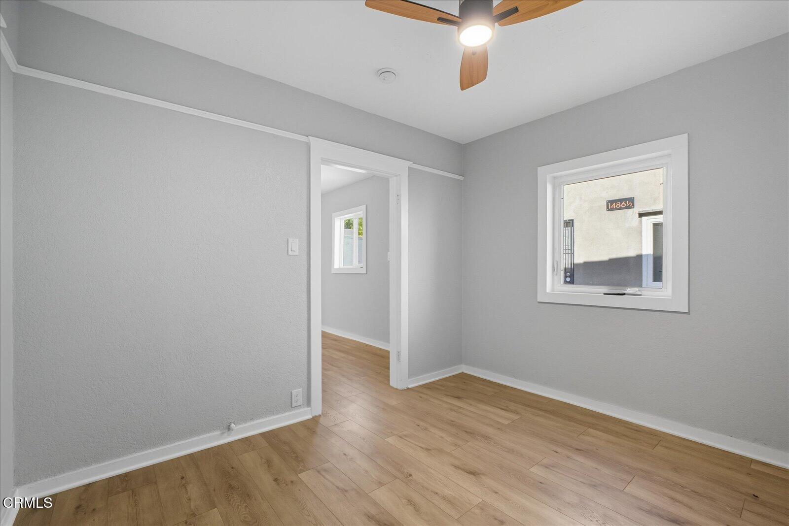 1488 Sunset Boulevard, Unit 1/4 Los Angeles, CA 90026 - Photo 18 of 30 wooden floor in an empty room with a window