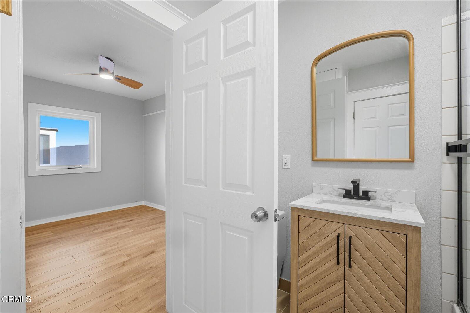 1488 Sunset Boulevard, Unit 1/4 Los Angeles, CA 90026 - Photo 21 of 30 a bathroom with a sink and a mirror