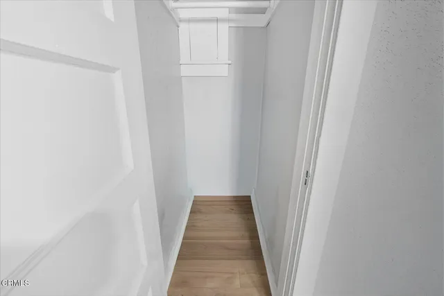 a view of a hallway with wooden floor