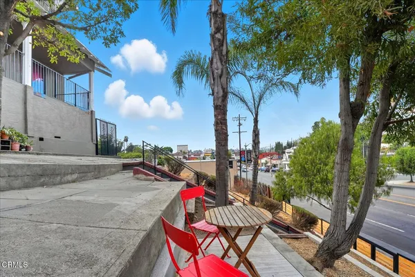 a view of a patio with couches and table under an umbrella