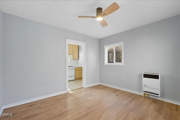 a view of empty room with wooden floor