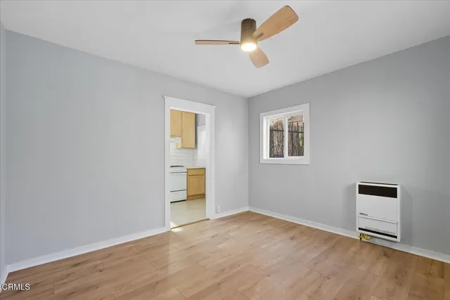 a view of empty room with wooden floor