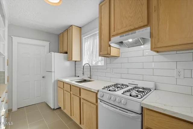 a kitchen with a stove a sink and a microwave