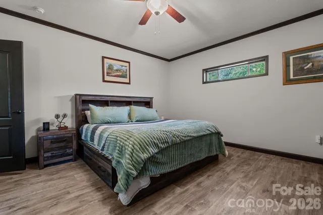 a bedroom with a bed and a chandelier