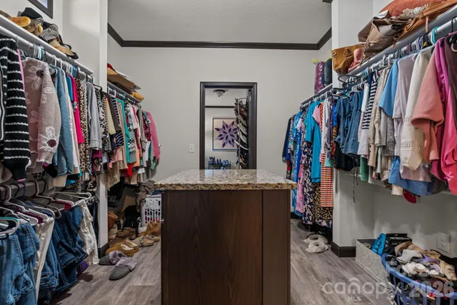 a view of walk in closet with clothes