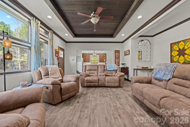 a living room with furniture ceiling fan and a rug