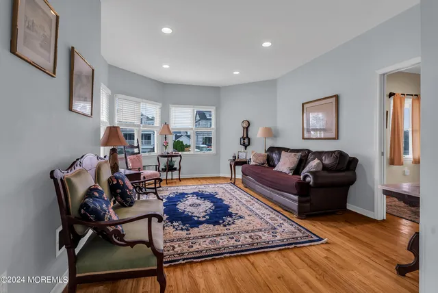 a living room with furniture rug and wooden floor