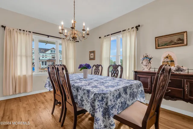 a view of a a dining room with furniture window and wooden floor
